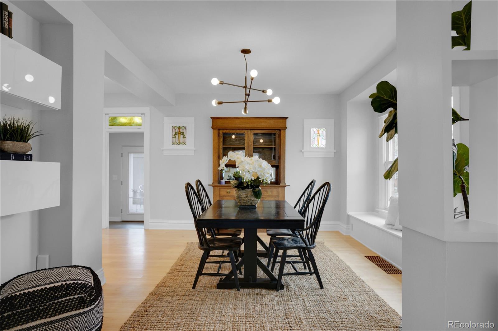 1283 Madison Street Denver, CO 80206 - Photo 10 of 34 a view of a dining room with furniture and wooden floor