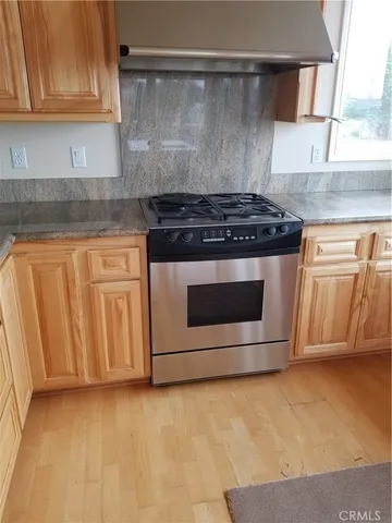 a stove top oven sitting inside of a kitchen