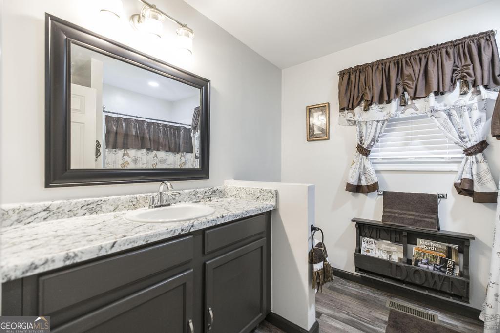 401 Pine Street Dublin, GA 31021 - Photo 26 of 27 a bathroom with a sink and a mirror