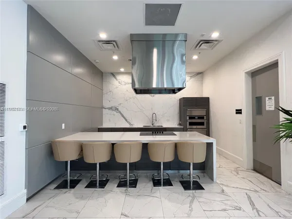 a kitchen with a dining table and chairs