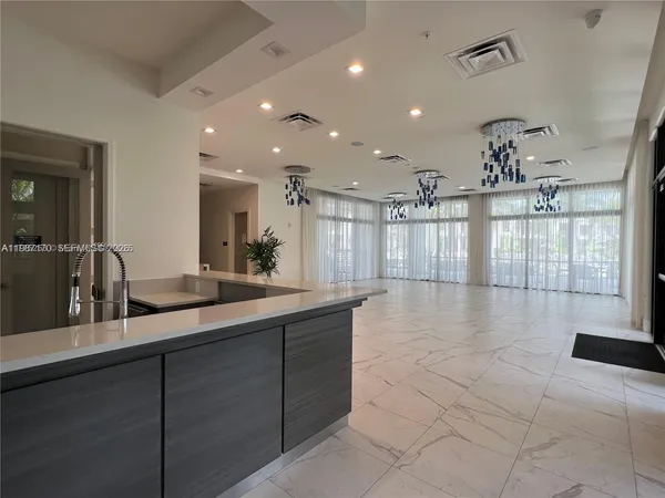 a lobby with a sink and chandelier