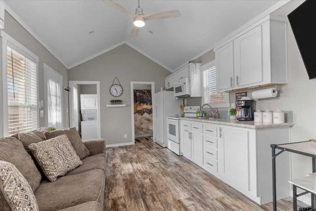 a kitchen with stainless steel appliances a stove refrigerator sink and microwave