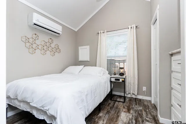 a bedroom with a bed and a wall painting