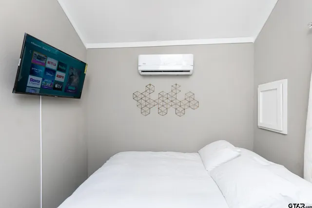 a bedroom with a bed and a dresser