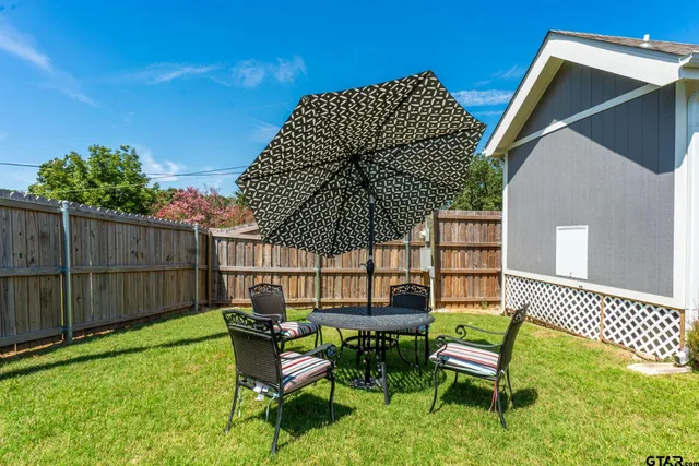 a house with beautiful flower in front of house