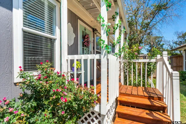 a view of a porch with chairs and flower plants