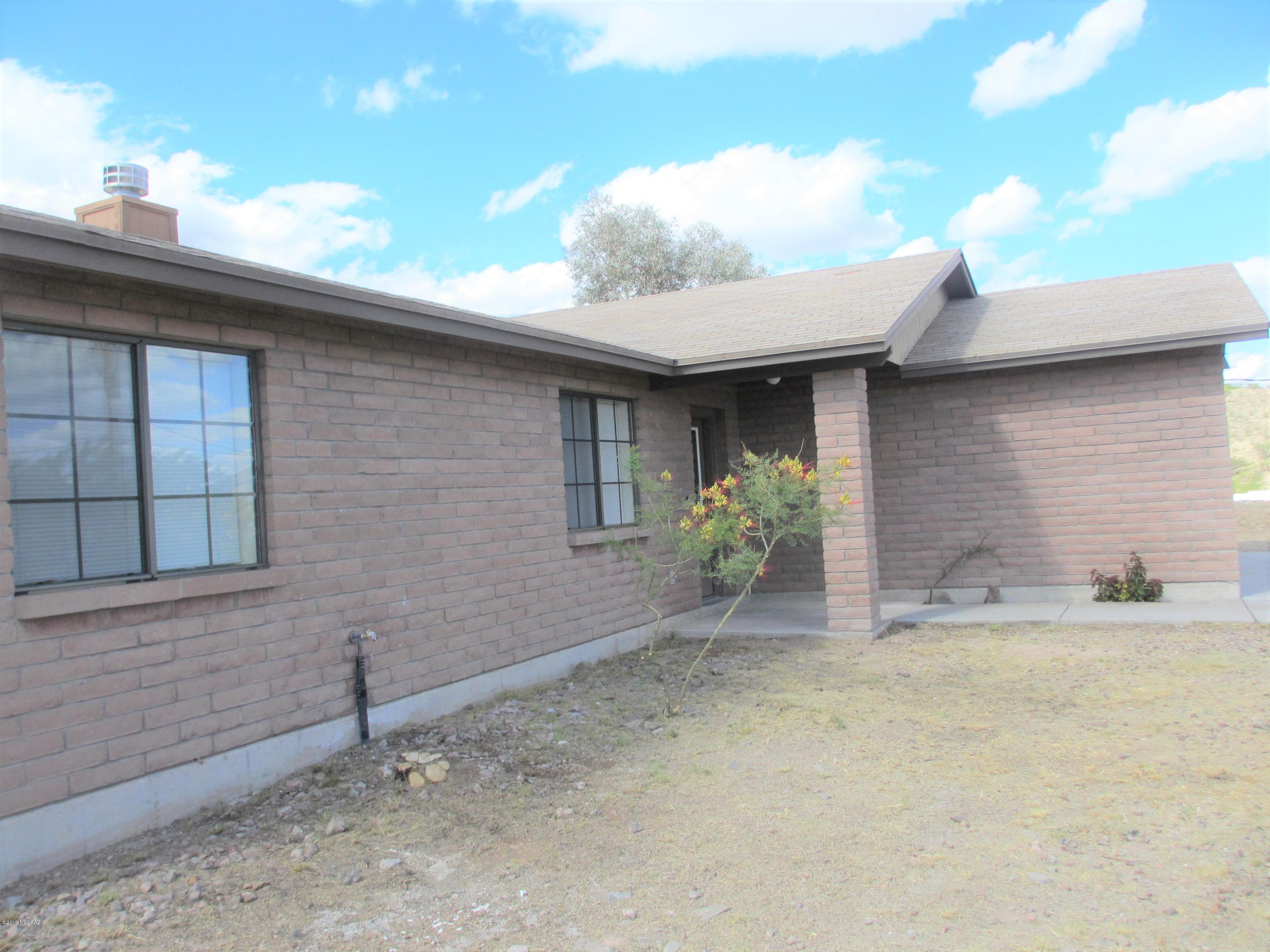 1084 Paseo Guebabi Rio Rico, AZ 85648 - Photo 5 of 33 a front view of a house with a yard
