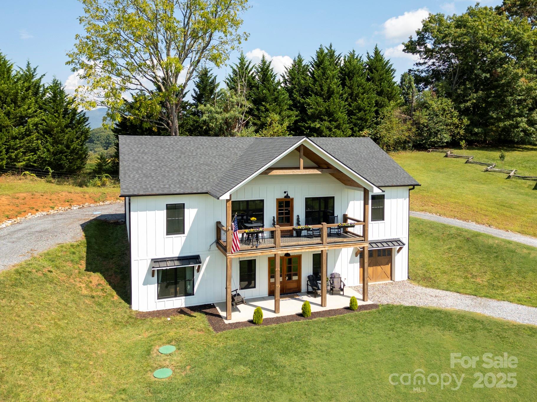 a view of a house with a yard patio and fire pit