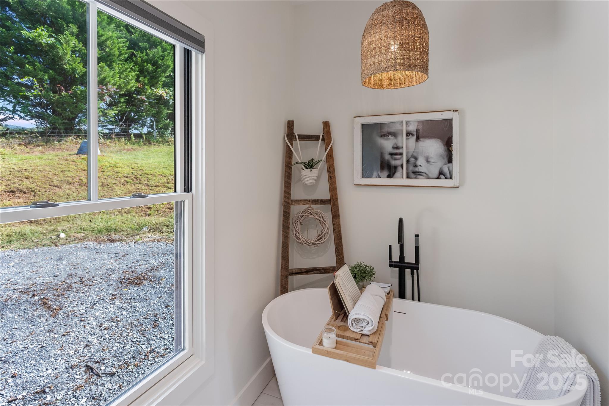 100 Kinloch Lane Clyde, NC 28721 - Photo 16 of 39 a bath tub sitting in a bathroom next to a window