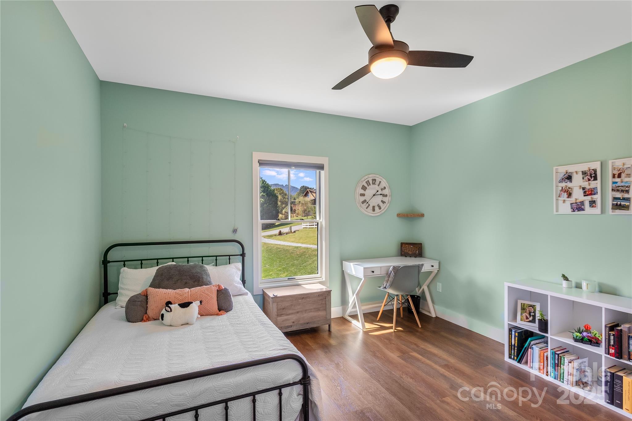 100 Kinloch Lane Clyde, NC 28721 - Photo 19 of 39 a bedroom with a bed and a chandelier