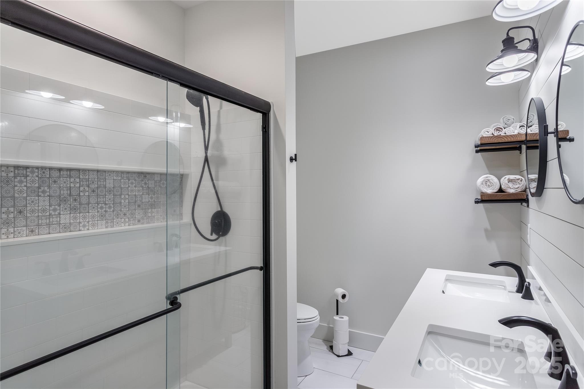 100 Kinloch Lane Clyde, NC 28721 - Photo 21 of 39 a bathroom with a granite countertop sink a toilet and shower