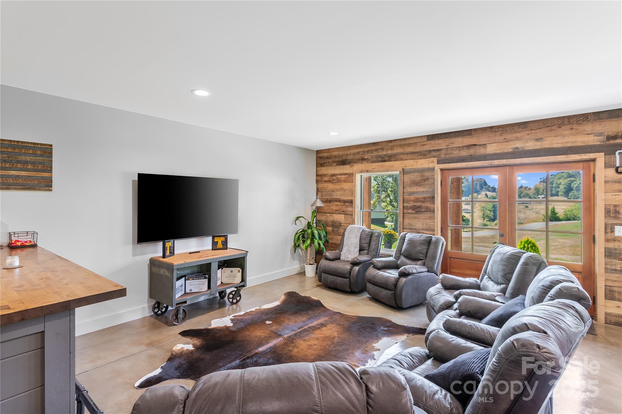 100 Kinloch Lane Clyde, NC 28721 - Photo 27 of 39 a living room with furniture and large flat screen tv