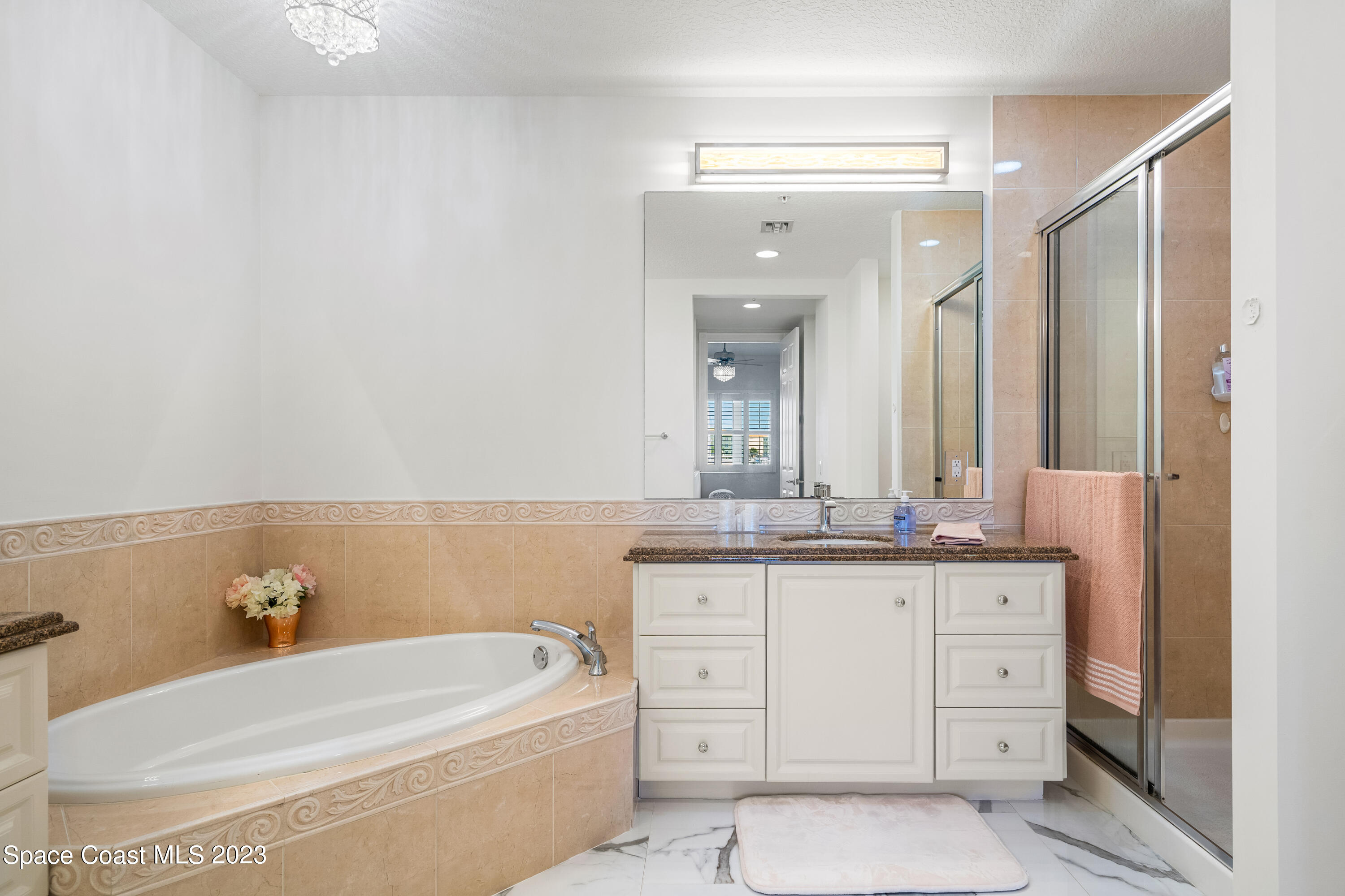 Undisclosed Address Fort Pierce, FL 34949 - Photo 21 of 36 a bathroom with a granite countertop sink tub and mirror