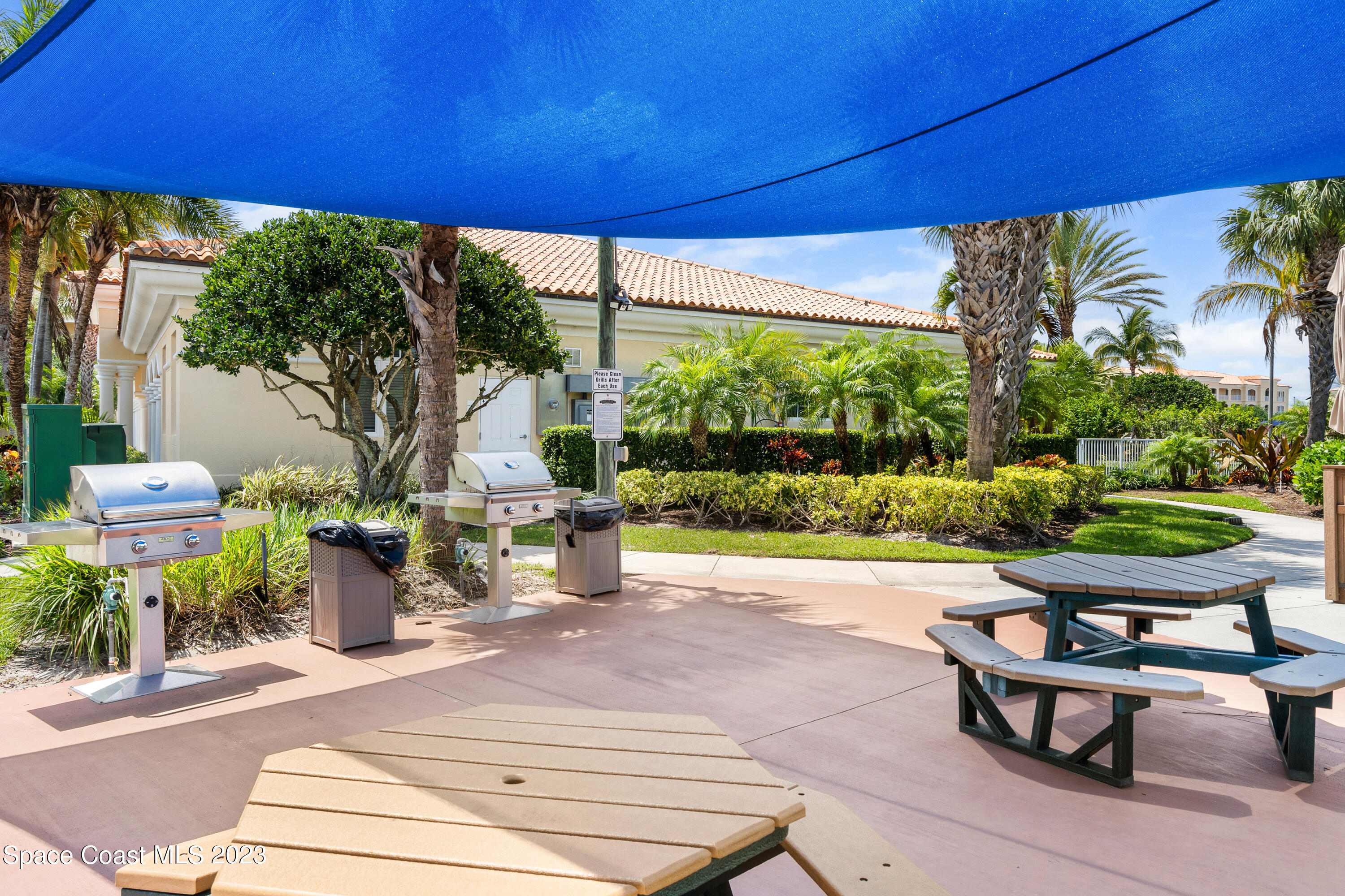 Undisclosed Address Fort Pierce, FL 34949 - Photo 34 of 36 a view of a patio with table and chairs potted plants and palm trees