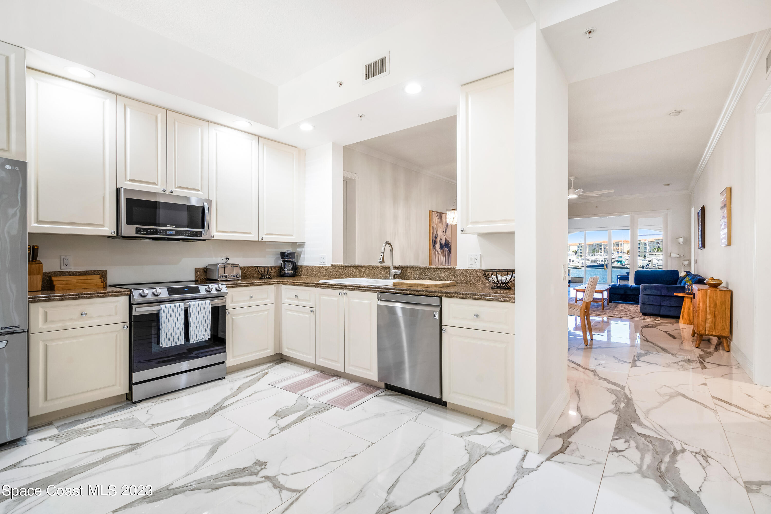 Undisclosed Address Fort Pierce, FL 34949 - Photo 4 of 36 a kitchen with granite countertop a stove a sink and a refrigerator
