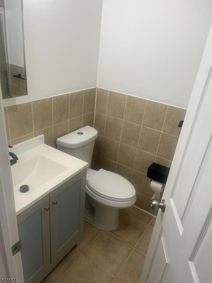 710 27th Street Union City, NJ 07087 - Photo 13 of 22 a bathroom with a sink a toilet and a mirror