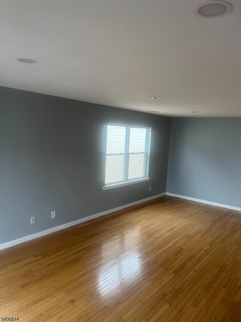 710 27th Street Union City, NJ 07087 - Photo 22 of 22 a view of an empty room with wooden floor and a window