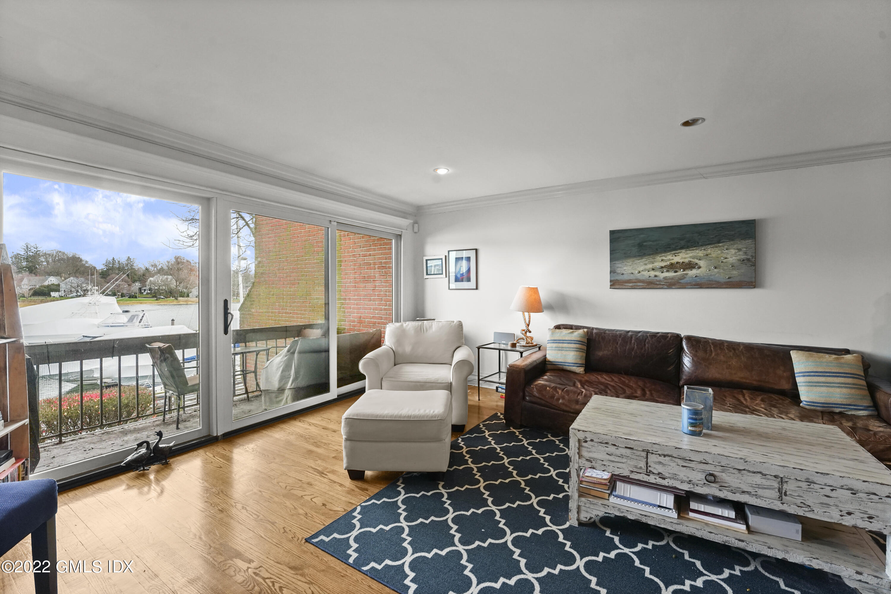 15 River Road, Unit 211 Cos Cob, CT 06807 - Photo 8 of 21 a living room with furniture and a floor to ceiling window