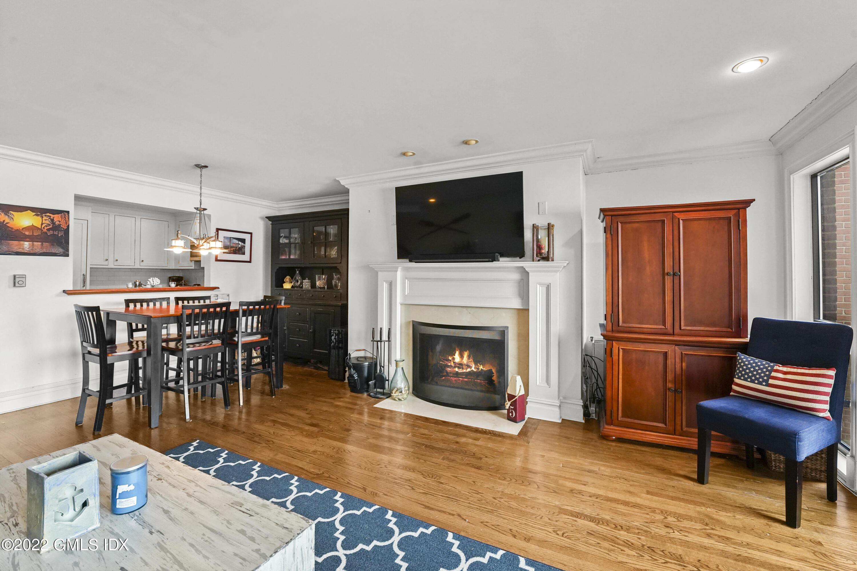 15 River Road, Unit 211 Cos Cob, CT 06807 - Photo 9 of 21 a living room with furniture a flat screen tv and a fireplace
