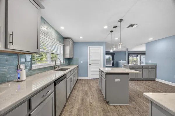 a kitchen with stainless steel appliances granite countertop sink stove and refrigerator