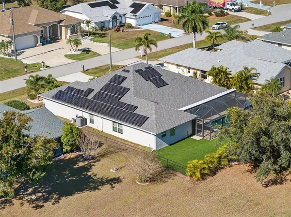an aerial view of a house with swimming pool and patio