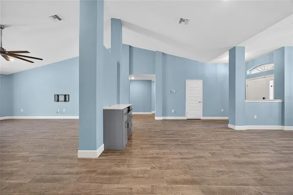 a view of an empty room with wooden cabinet