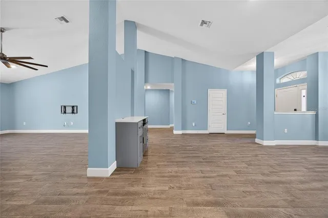 a view of an empty room with wooden cabinet