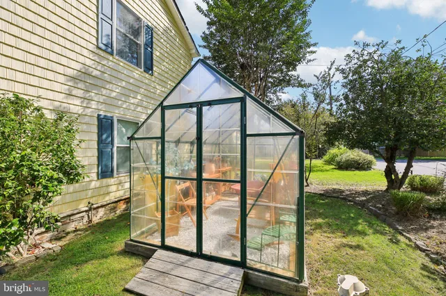 a kitchen with stainless steel appliances granite countertop a refrigerator and chairs