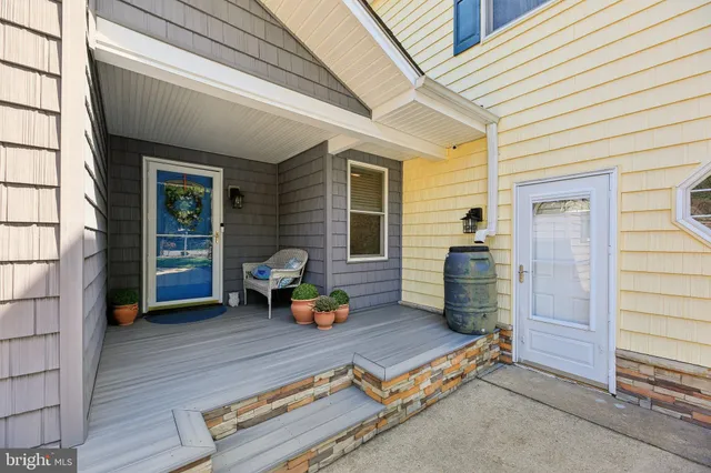a kitchen with granite countertop a sink stainless steel appliances and white cabinets