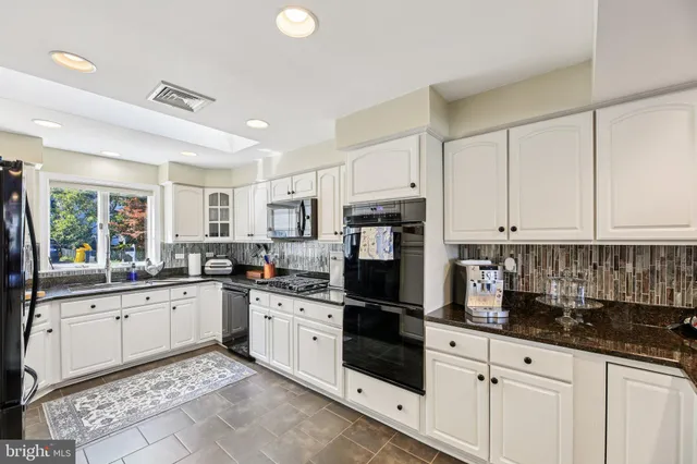 a spacious bathroom with a granite countertop sink toilet and shower