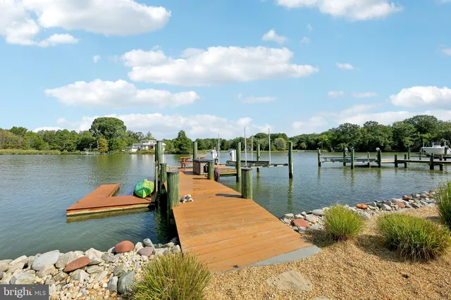 a view of a house with swimming pool and ocean view