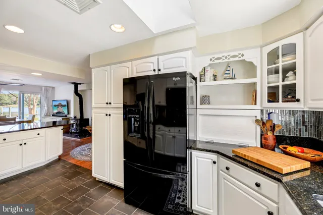 a view of a workspace with furniture and a ceiling fan