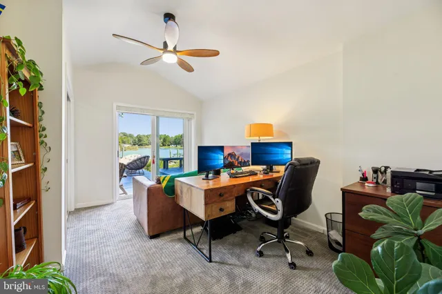a bedroom with a bed a couch and potted plant