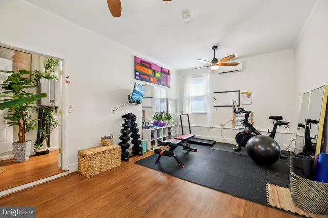 a kitchen with granite countertop a stove a sink dishwasher and a dining table with wooden floor