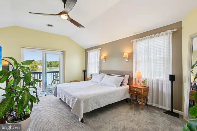 a view of a patio with couches table and chairs and potted plants