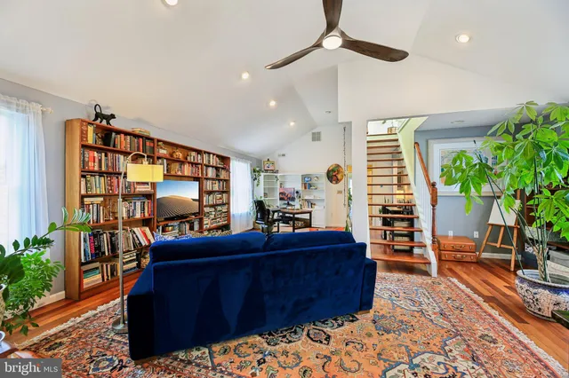 a yellow house with trees in front of it
