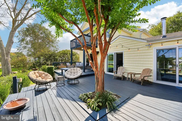 a front view of a house with garden and sitting area