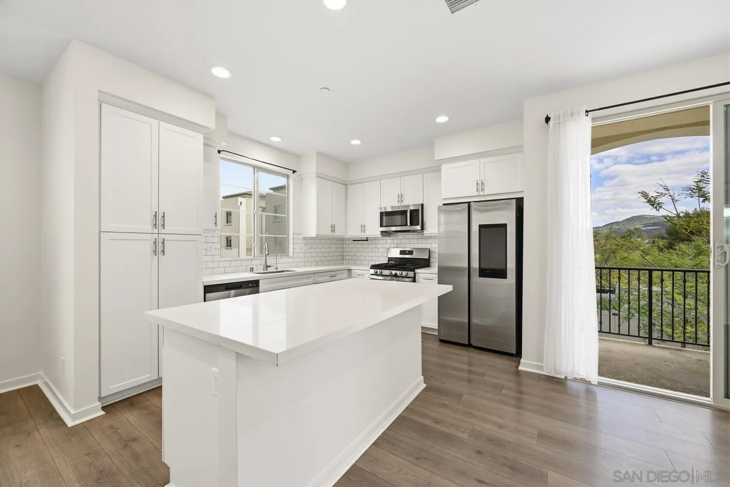 429 Lake Shore Way Santee, CA 92071 - Photo 1 of 26 a large kitchen with stainless steel appliances a refrigerator a stove a sink dishwasher a oven with white cabinets and wooden floor