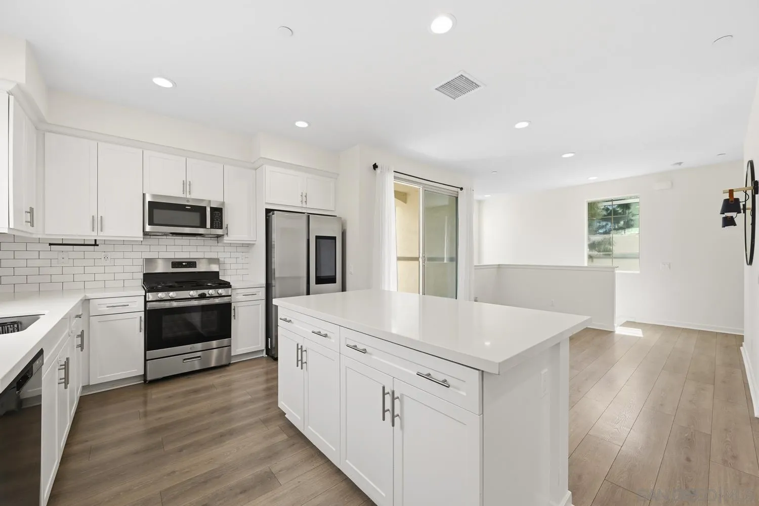429 Lake Shore Way Santee, CA 92071 - Photo 11 of 26 a kitchen with granite countertop white cabinets and stainless steel appliances
