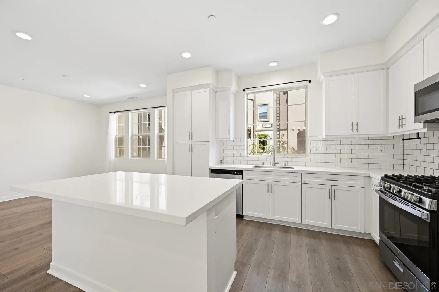 429 Lake Shore Way Santee, CA 92071 - Photo 12 of 26 a large white kitchen with sink a stove and white cabinets