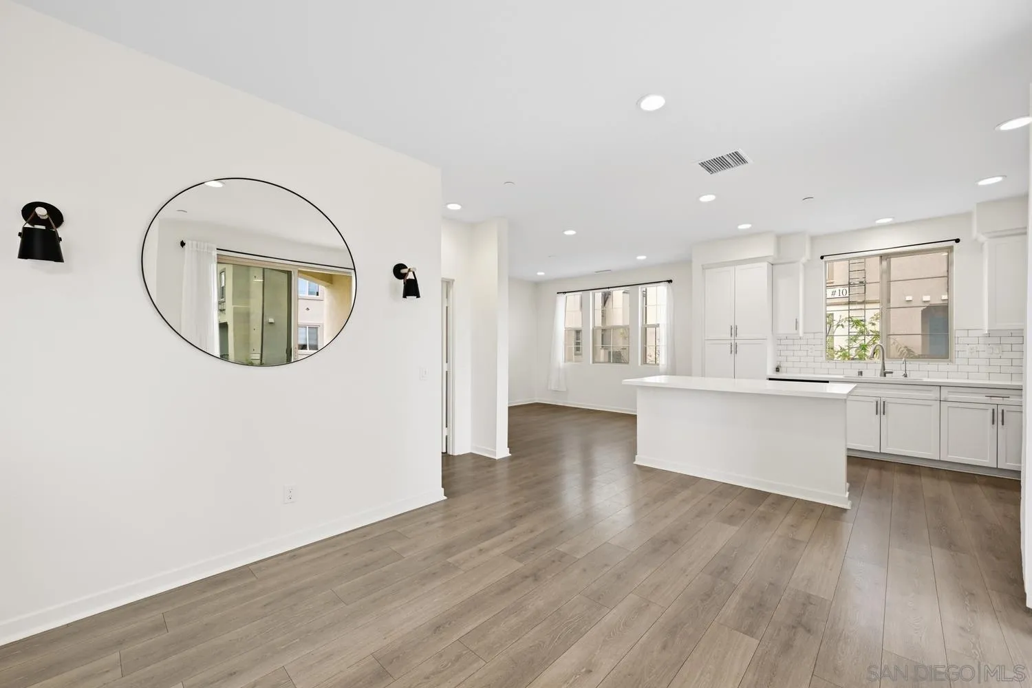 429 Lake Shore Way Santee, CA 92071 - Photo 10 of 26 an empty room with wooden floor kitchen view and kitchen view