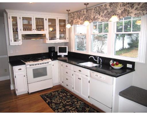 81 Gleason Road Lexington, MA 02420 - Photo 8 of 18 a kitchen with granite countertop a stove a sink and wooden cabinets