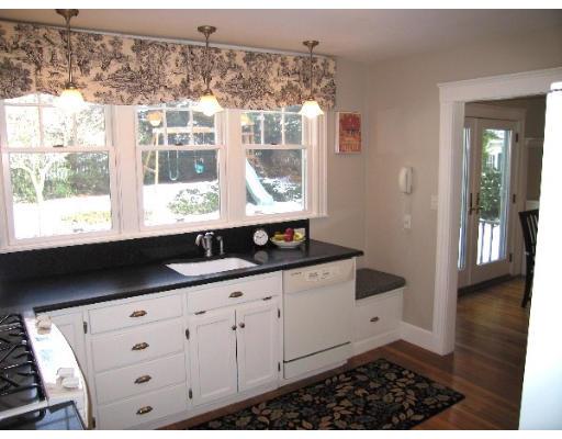 81 Gleason Road Lexington, MA 02420 - Photo 9 of 18 a kitchen with granite countertop white cabinets and wooden floor