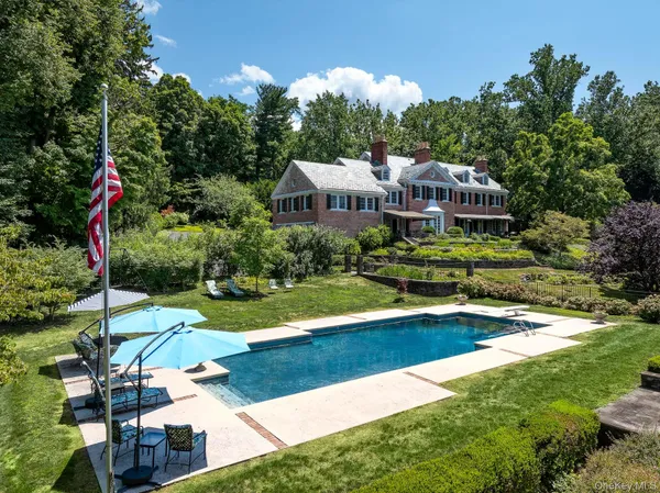 a aerial view of a house with swimming pool and garden