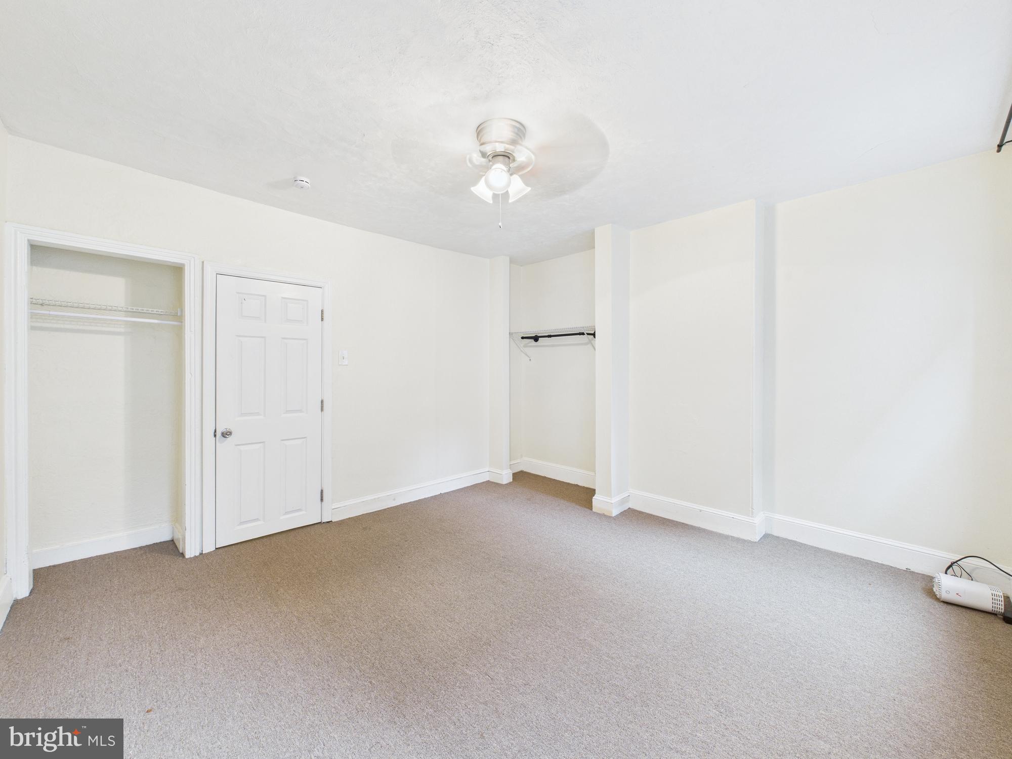 1825 Carlton Street Philadelphia, PA 19103 - Photo 15 of 28 an empty room with a ceiling fan and a window