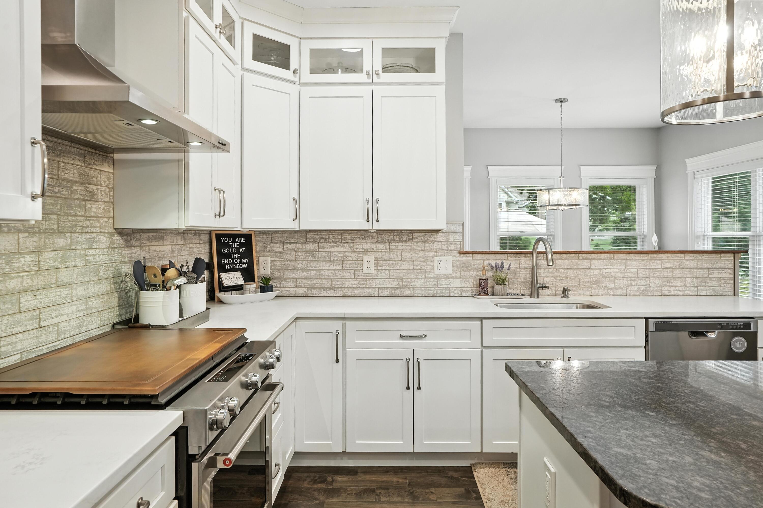 1285 Greenview Place Crown Point, IN 46307 - Photo 14 of 51 a kitchen with granite countertop a sink a stove and cabinets