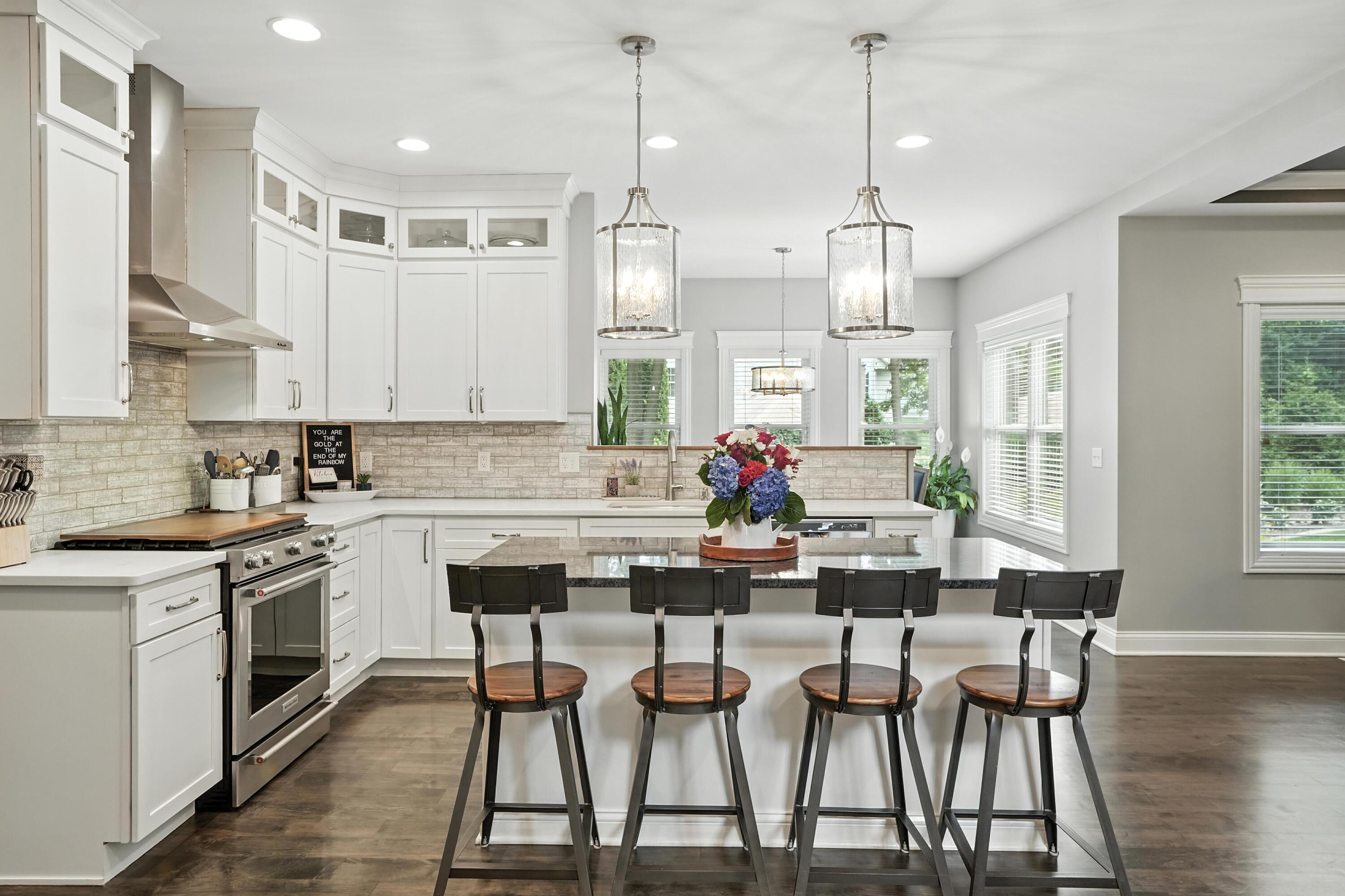 1285 Greenview Place Crown Point, IN 46307 - Photo 16 of 51 a kitchen with stainless steel appliances a dining table chairs and white cabinets