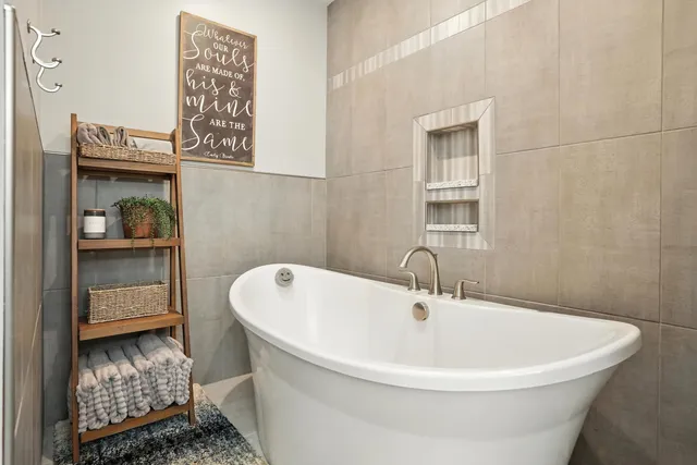 a white bath tub sitting next to a bathroom
