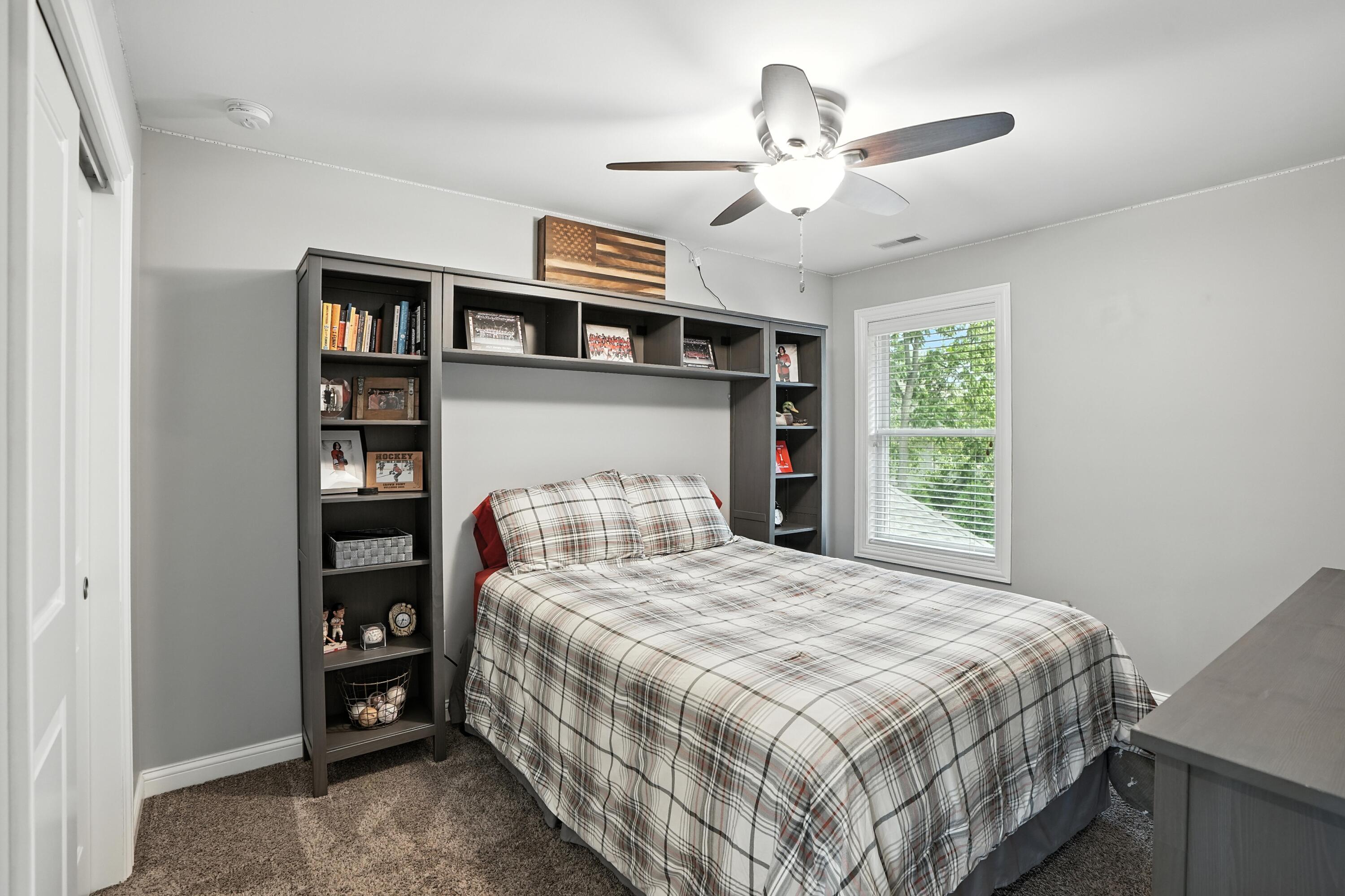 1285 Greenview Place Crown Point, IN 46307 - Photo 33 of 51 a bedroom with a bed and a chandelier
