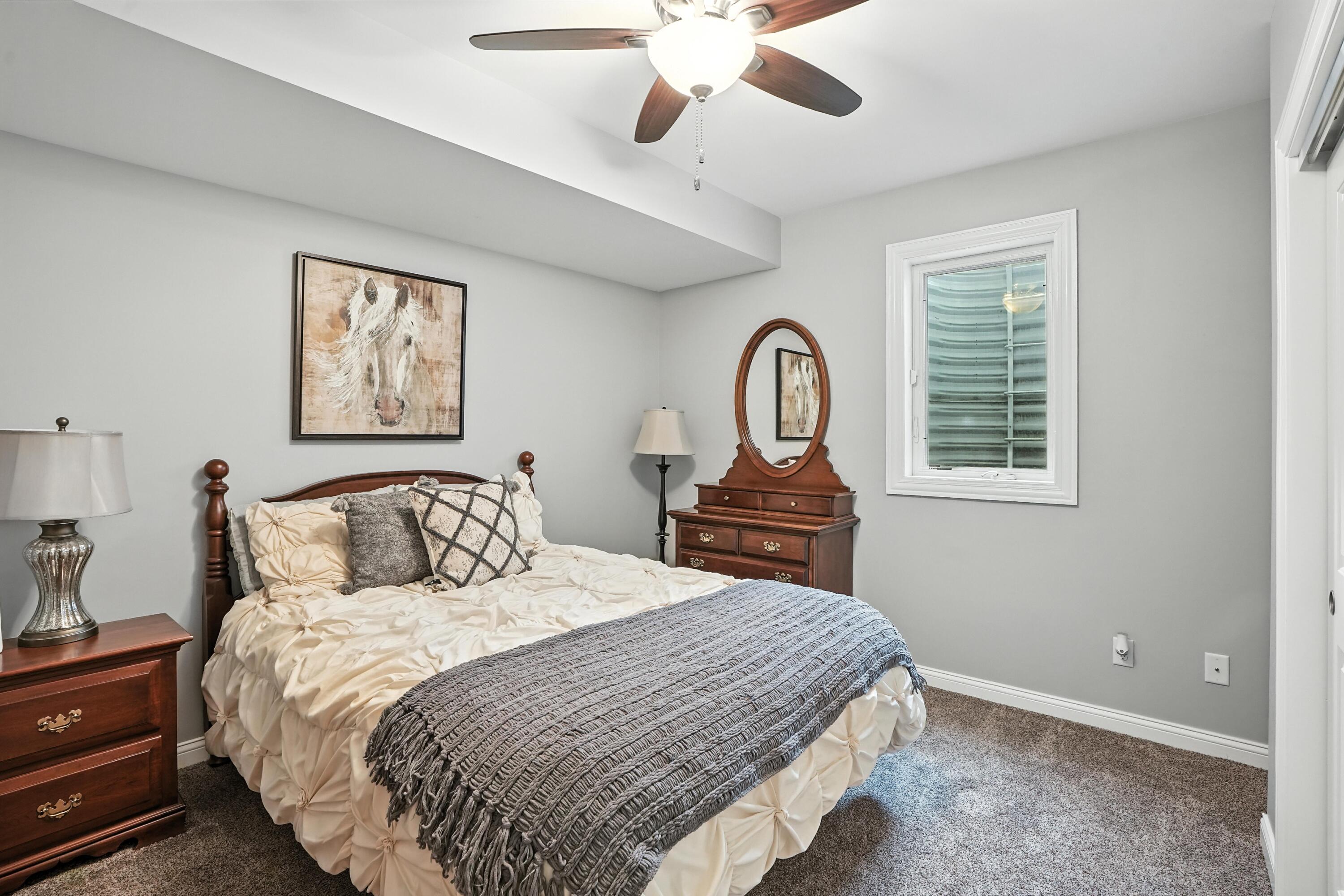 1285 Greenview Place Crown Point, IN 46307 - Photo 39 of 51 a bedroom with a bed and a chandelier